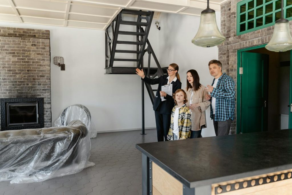 Family and agent exploring a stylish new home interior together.